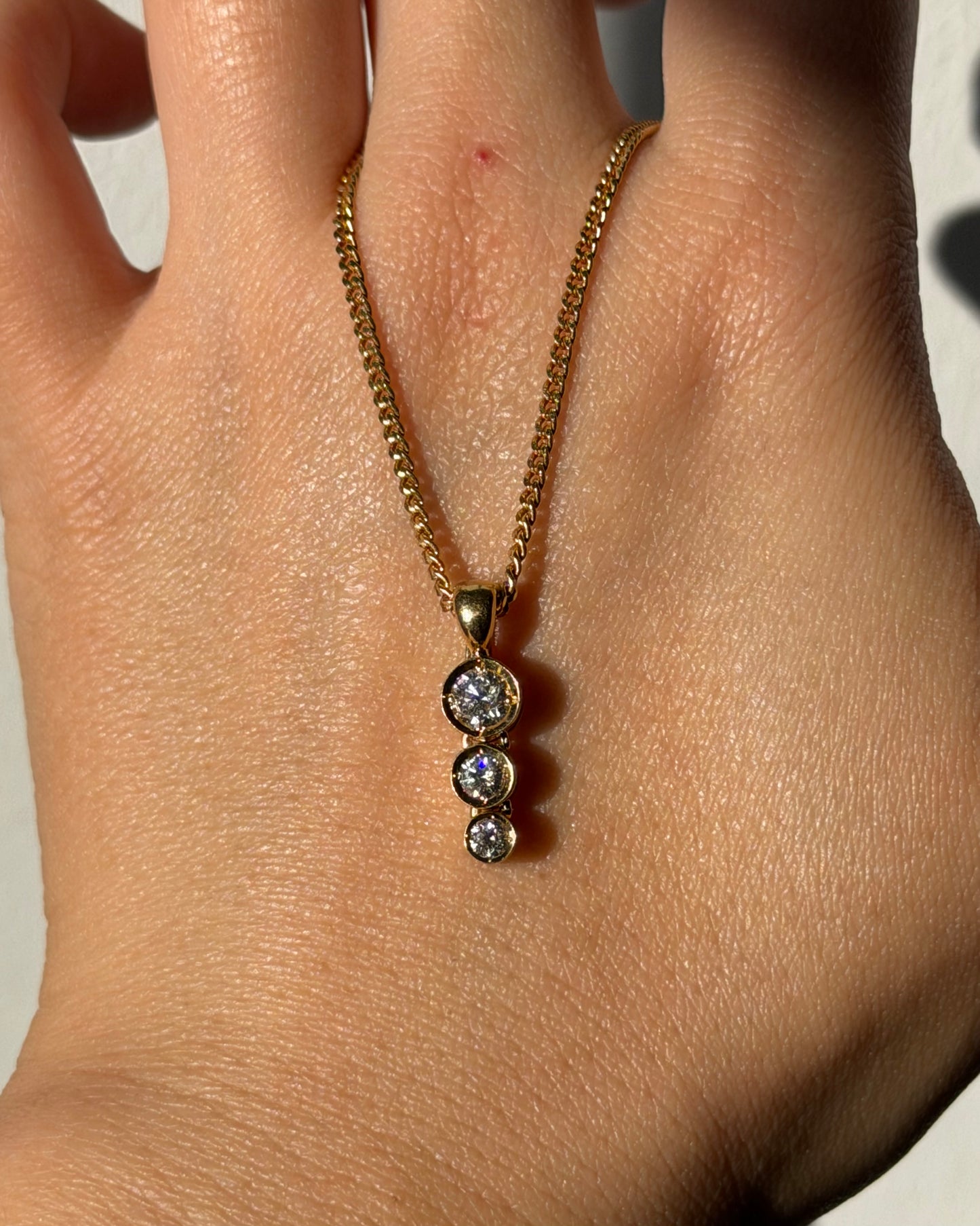 Modern Pre-loved 18k Gold Bezel Set Graduated Diamond Pendant with Clip Bail