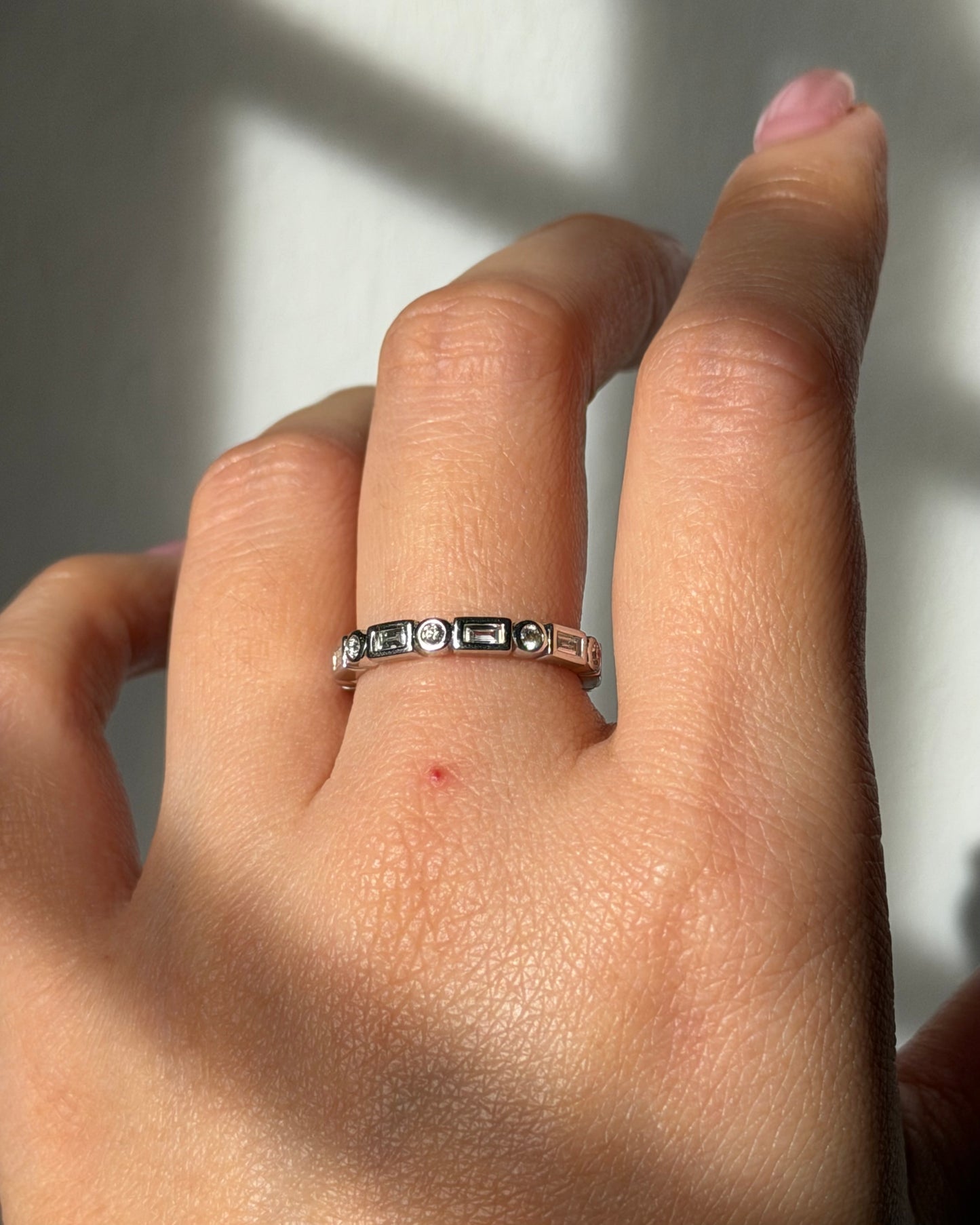 Modern Pre-loved 18k White Gold Bezel Set Baguette and Round Diamond Stacking Band