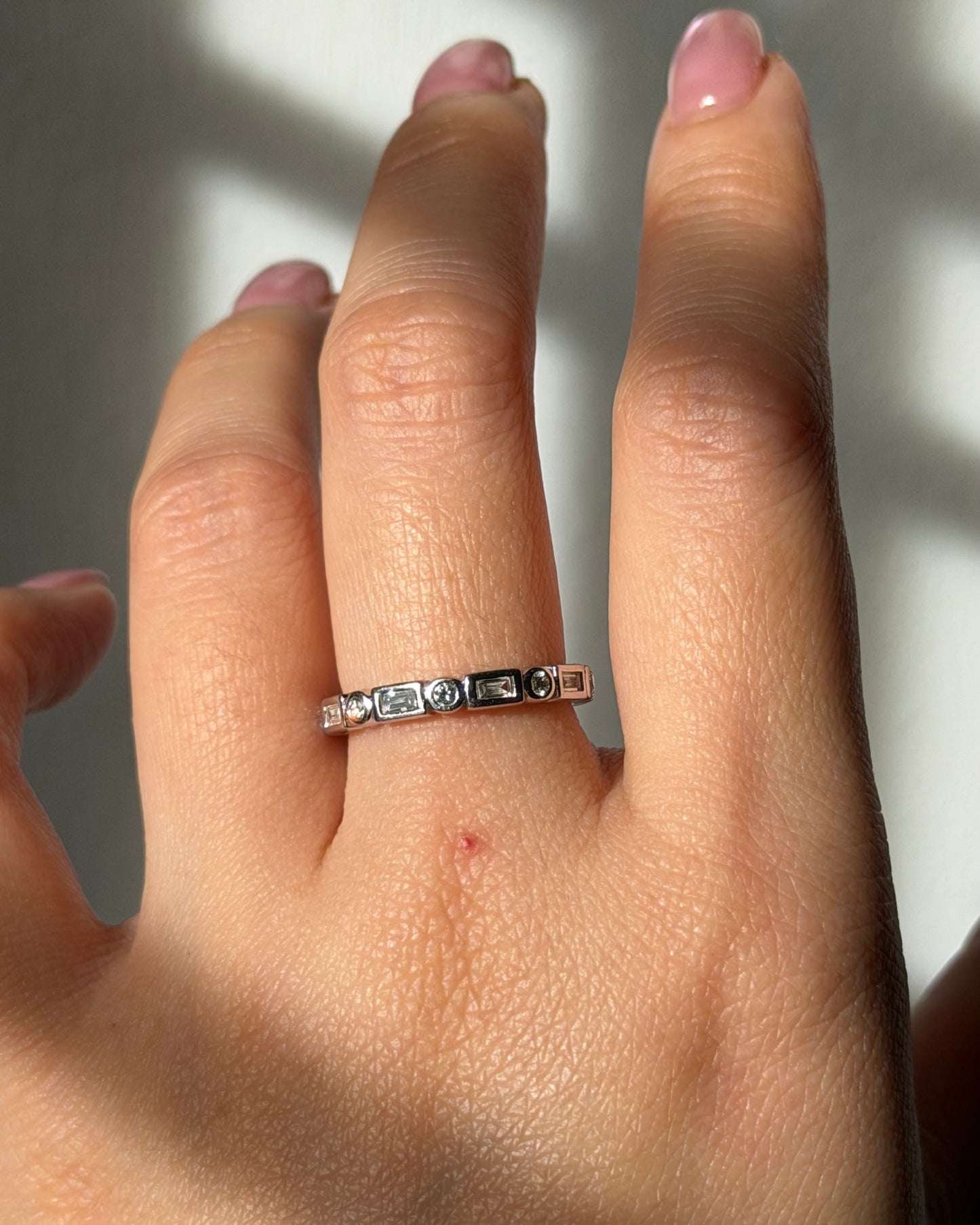 Modern Pre-loved 18k White Gold Bezel Set Baguette and Round Diamond Stacking Band