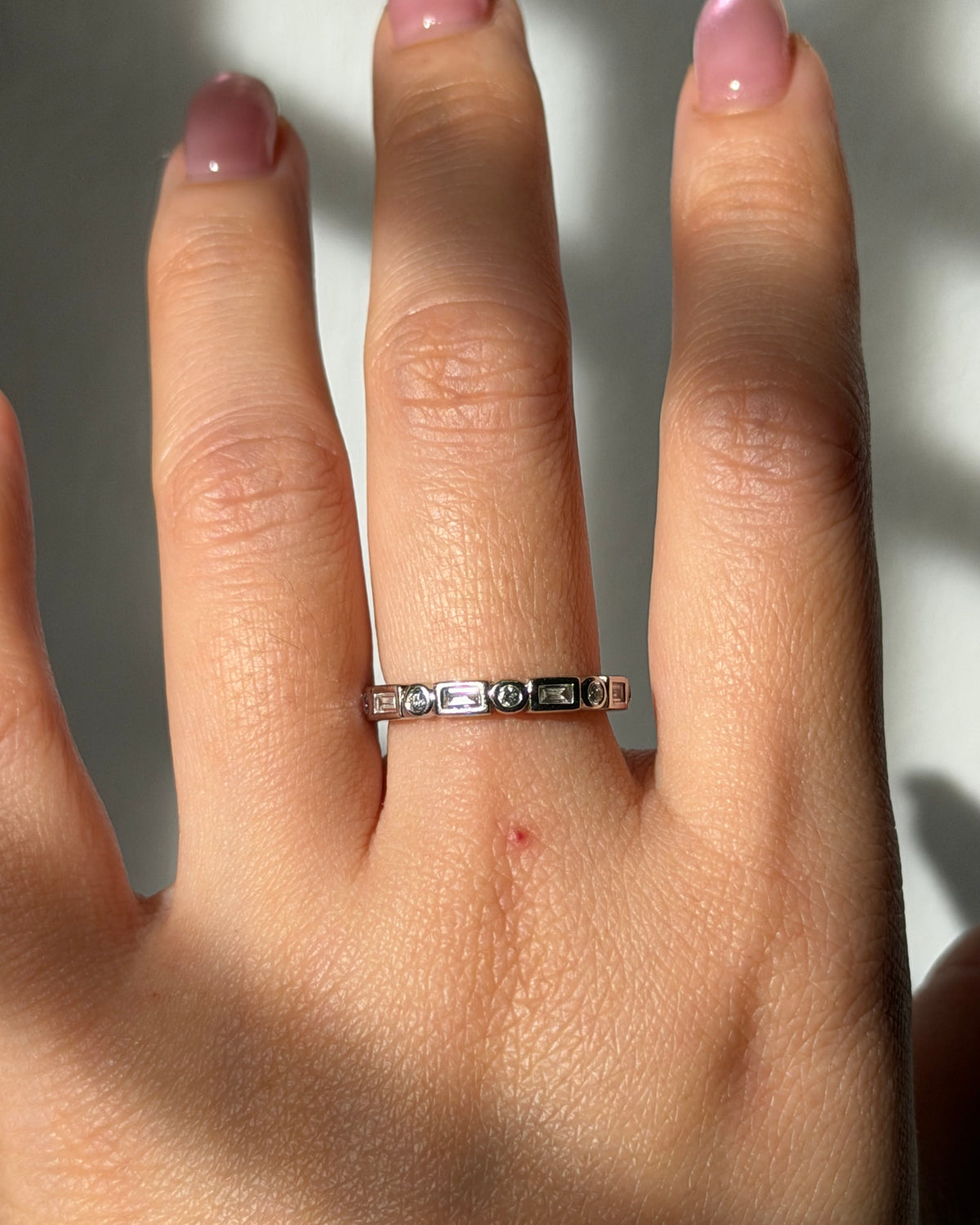 Modern Pre-loved 18k White Gold Bezel Set Baguette and Round Diamond Stacking Band
