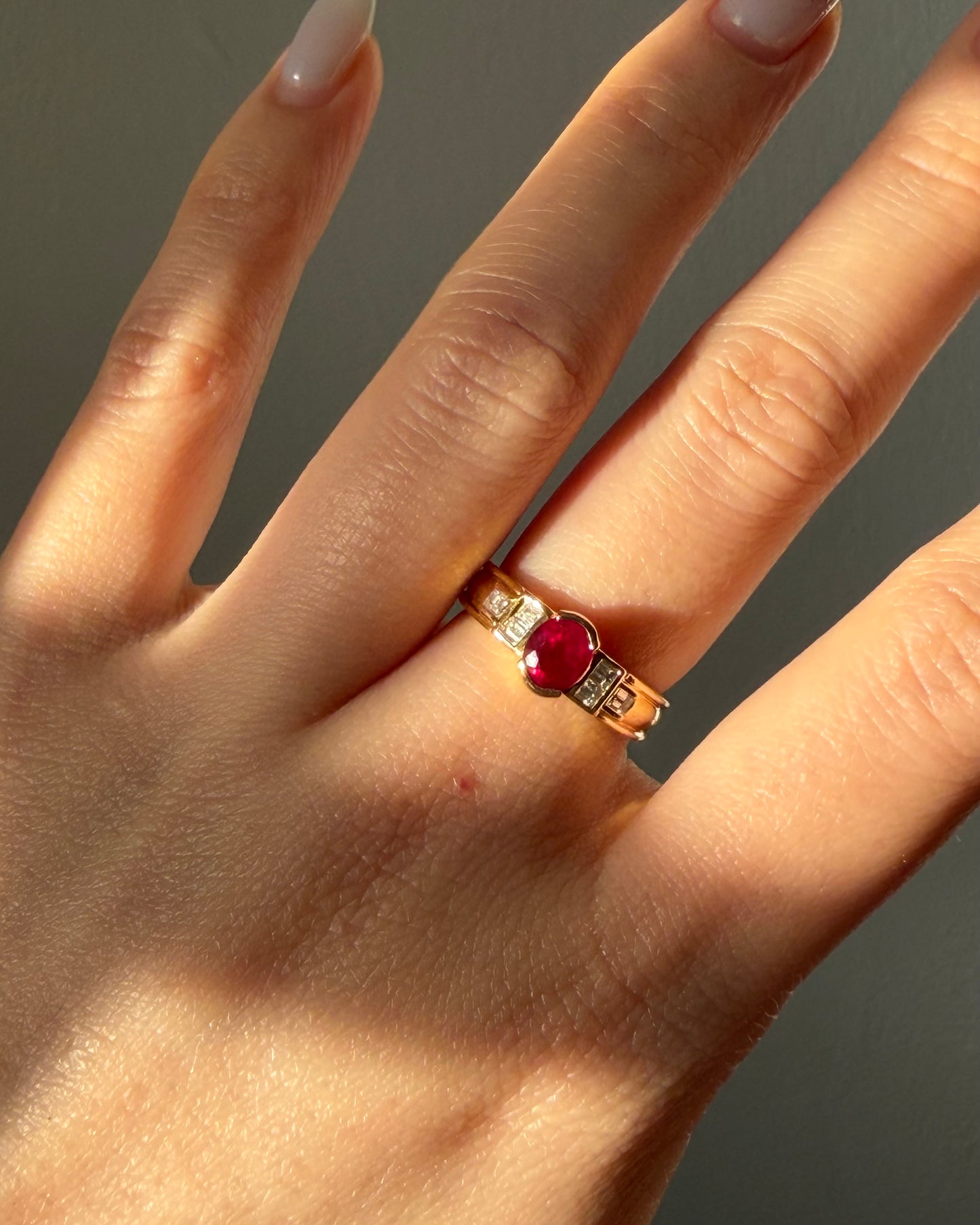 Art deco bezel set ruby ring with baguette diamond shoulders